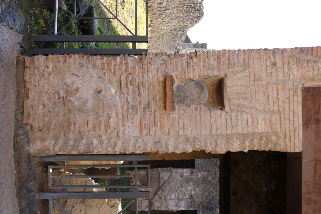 Street shrine or niche outside I.12.5 Pompeii. September 2005. This is on Via dell’ Abbondanza, at the corner with Vicolo dei Fuggiaschi. According to Della Corte, on the red pilaster which ended the insula on the east side, two electoral programmes were found.
The first – GAVIVM II VIR. The second was immediately below the first  - AMPLIATUM  L F AED
                                                                                                                  VICINI                                                                                                           
                                                                                                             SVRGITE ET
                                                                                                             ROGATE
                                                                                                             LVTATI F[ac]     
The text was placed towards the right, because the pilaster was interrupted in the middle by a rectangular niche. In the niche was fixed a coarse, rough stone resembling the outline of a human head, not the usual marble bust, as often seen here and there in the street.
See Notizie di Scavi, 1914, (p.204). According to Epigraphik-Datenbank Clauss/Slaby (See www.manfredclauss.de), these are numbered CIL IV 7442 and CIL IV 7443.