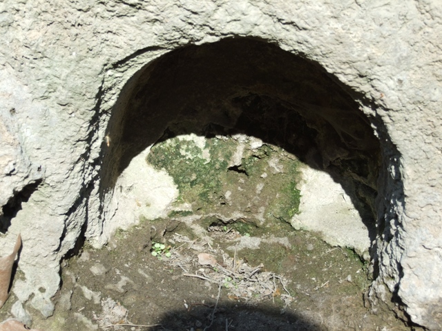 The buried altar under the small niche.