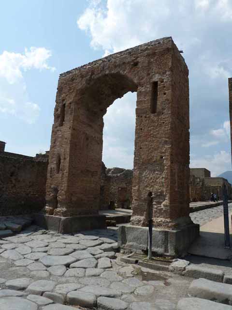 Arch of Caligula. May 2010. Looking north from arch at the start of the Via Mercurio. A bronze equestrian statue was found in pieces beneath the arch. This was (arbitrarily) identified as being Caligula and may have come from the top of the arch. Now in Naples Archaeological Museum. Inventory number 5635. According to Welch, the statue wears a toga and senatorial sandals and is realistically portrayed as middle aged. She suggests it is more likely to be a high ranking civic person. She suggests that it may be Marcus Tullius who was tribunus militum a populus a non military but equestrian rank. He was also the donor of the adjacent Temple of Fortuna Augustus in the Augustan period. See Welch K. E. in Dobbins, J. J. and Foss, P. W., 2008. The World of Pompeii. Oxford: Routledge. (p.551-554, fig. 36.2a-c).