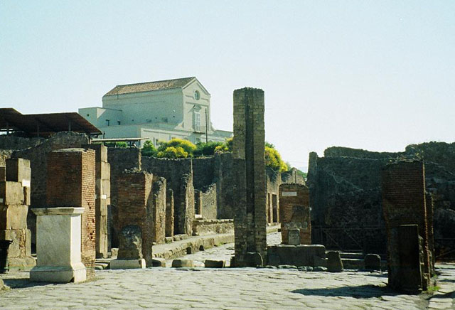 Arch of Marcus Holconius Rufus. May 2010. Site of arch at Holconius’ crossroads.
This was a large arch at the major crossroads of Via dell’Abbondanza and Via Stabiana
Looking east along Via dell’Abbondanza to junction with Via Stabiana.
According to Liselotte Eschebach this is a Tetrapylon.
See Eschebach, L., 1993. Gebäudeverzeichnis und Stadtplan der antiken Stadt Pompeji. Köln: Böhlau. (Pages 244-5).
According to Wikipedia, A tetrapylon (Greek: Τετράπυλον, "four gates") is an ancient type of Roman monument of cubic shape, with a gate on each of the four sides: generally it was built on a crossroads.