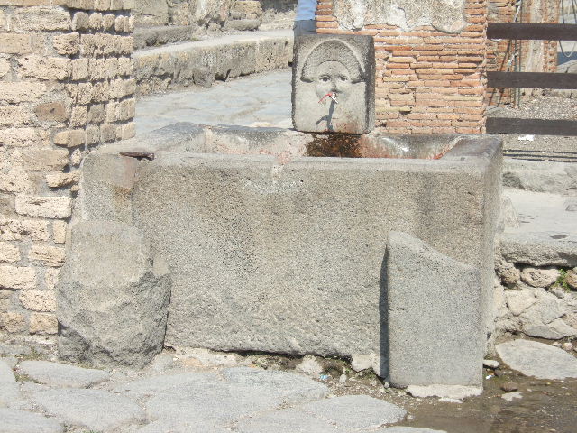Fountain outside I.4.15 on Via Stabiana. May 2010. East side of fountain and water column on the south side of the Via dell'Abbondanza, at the junction with Via Stabiana. 
