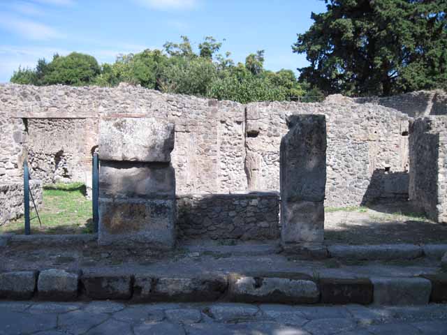 I.1.1 Pompeii. September 2005.  Stone podium or sales counter, with kitchen and hearth. There was also a latrine under the steps to the upper floor. (No longer visible).