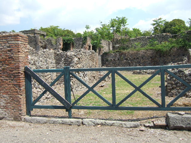 I.1.8 Pompeii. September 2010. Doorway to room on north side of yard, possibly a dormitory. The remains of the steps to upper floor are on the left of the photo. Photo courtesy of Drew Baker.