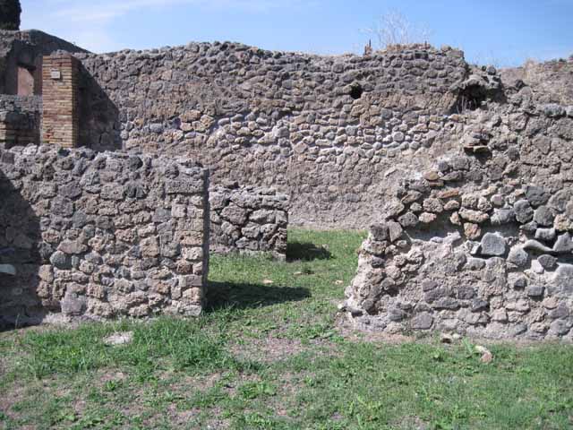 I.1.8 Pompeii. September 2010. Looking south across yard, behind the wall on the left would have been the stables area. Photo courtesy of Drew Baker.