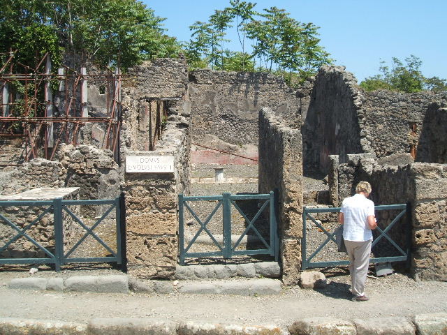 I.2.10 Pompeii. September 2010. Remains of north wall of atrium (north-east side), with doorway to rear of house, on right. Looking north towards I.2.11/12/13/14. Photo courtesy of Drew Baker.