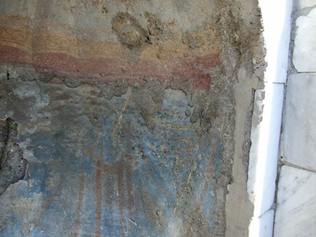 I.2.17 Pompeii. March 2009. South end of niche on east wall. Detail of the remains of painted blue drapery
