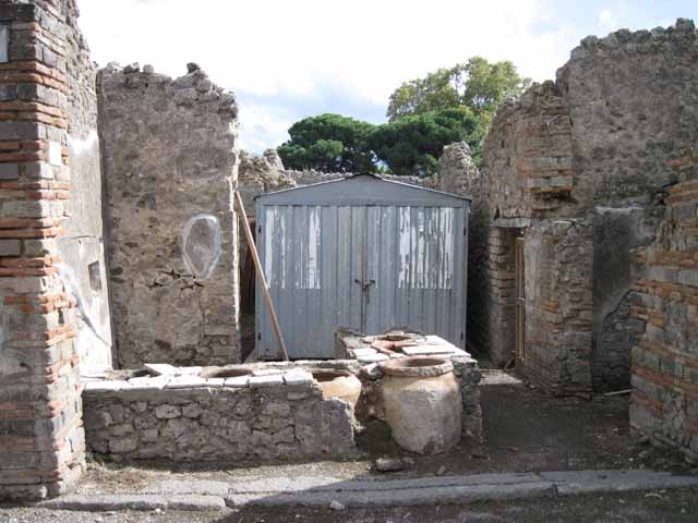 I.2.18 Pompeii. September 2010. Looking west from rear of bar counter, towards doorway to peristyle garden of I.2.17. Photo courtesy of Drew Baker.
