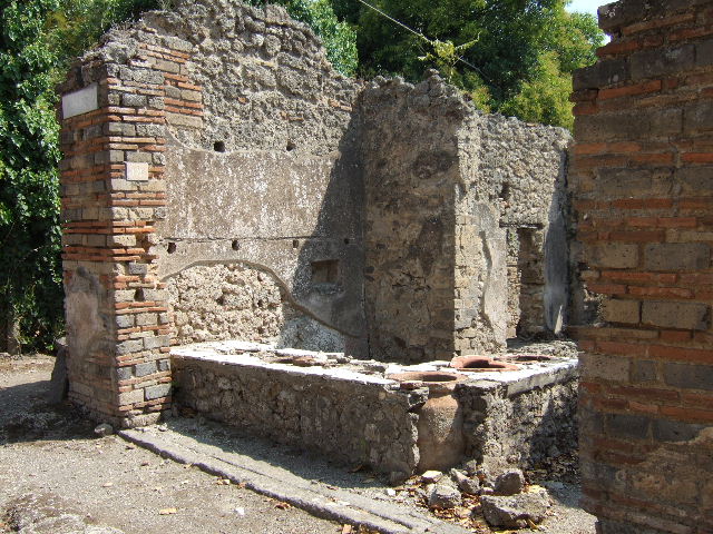 I.2.18 Pompeii. September 2010. Looking north towards front of bar, from rear room in south-west corner. Photo courtesy of Drew Baker 
