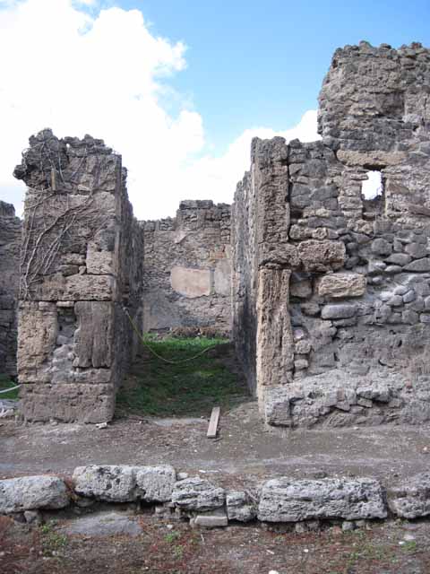 I.2.24 Pompeii. September 2010.  South side of room, looking south through I.2.25 onto Vicolo del Conciapelle . Photo courtesy of Drew Baker.
