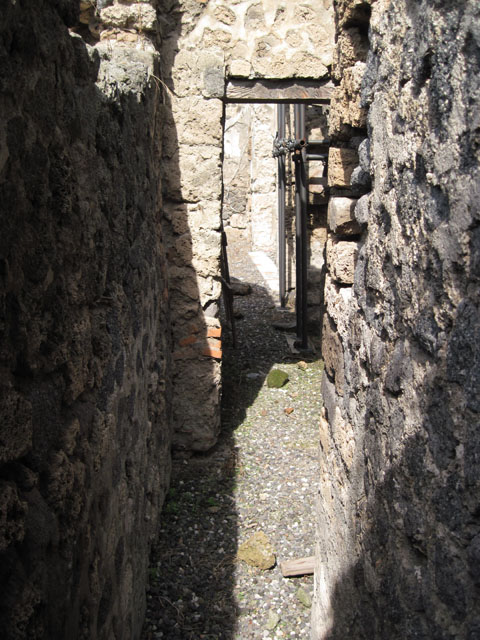 I.3.3 Pompeii. September 2010. Looking south across kitchen area towards entrance doorway at I.3.3, and unnamed vicolo. Photo courtesy of Drew Baker.
