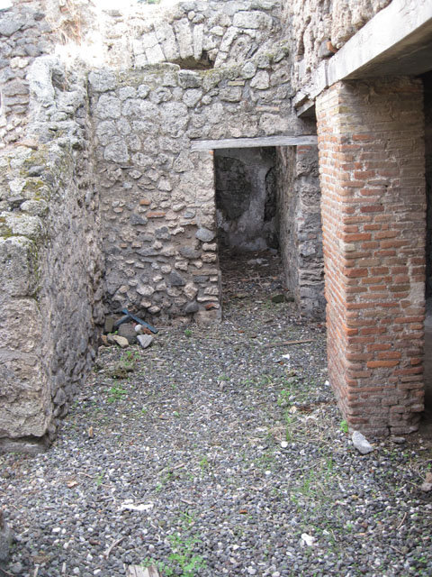 I.3.3 Pompeii. September 2010. Looking west in kitchen towards hearth in niche in south-west corner. Photo courtesy of Drew Baker. According to Mau, the smoke from the hearth passed through a window and two brick pipes buried in the vault. Mau, A: BdI, 1874, p.179

