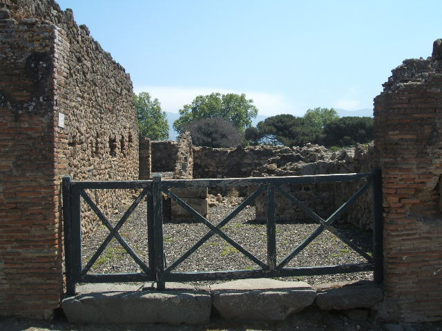 I.3.13 Pompeii. September 2010. Number ID plate. Looking east along Vicolo del Menandro. Photo courtesy of Drew Baker.