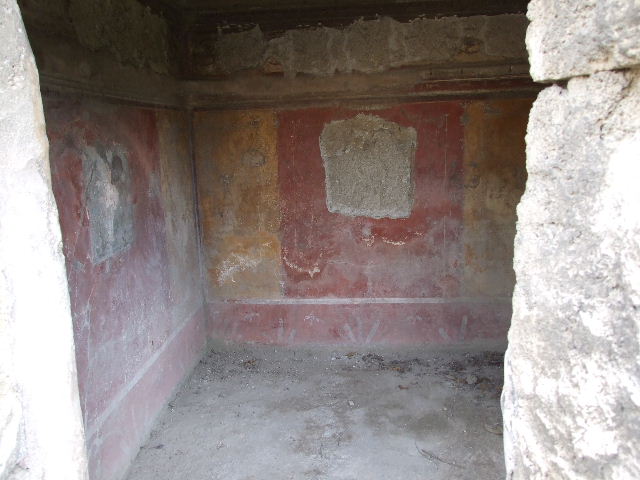 I.3.25 Pompeii. December 2006. Oecus. Detail of wall painting of (Egyptian?) deity in north-east corner.