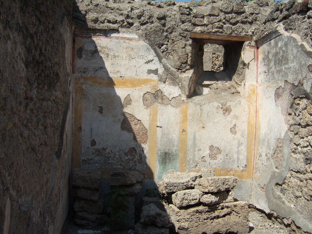 I.5.2 Pompeii. September 2010. East wall of small room, centre with fresco work. Photo courtesy of Drew Baker.