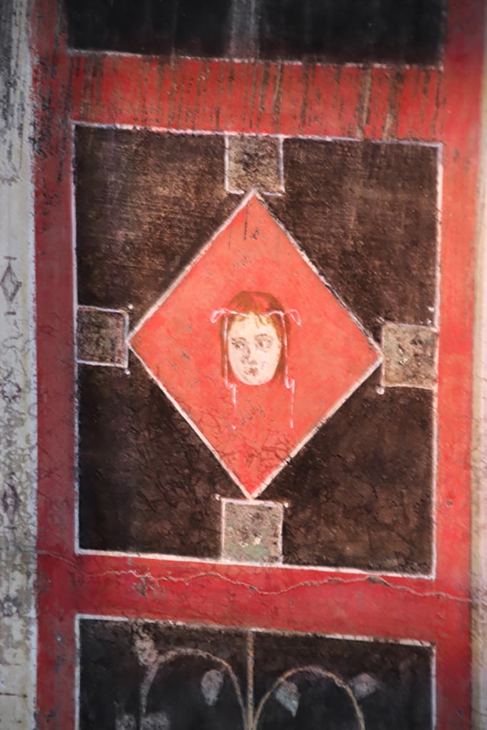 I.9.5 Pompeii. October 2022. 
Room 10, detail from centre of east wall of triclinium. Photo courtesy of Klaus Heese.

