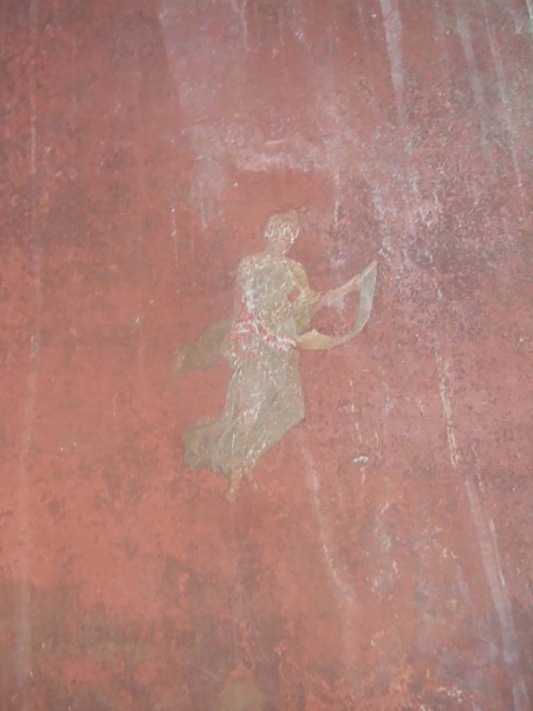 I.10.4 Pompeii. May 2006. 
Room 18, west wall on south side of doorway to peristyle, painting of floating Muse with roll of paper. 
