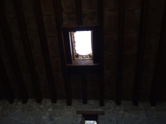 I.10.16 Pompeii. March 2009. Niche in atrium. According to Boyce, on this west wall above a small hearth was an arched niche with projecting floor. Its inside walls were coated with the same rough stucco as the walls of the room. When Boyce wrote, he said that still standing within the niche were three terracotta lamps. They each had a single nozzle, two of them were ornamented with reliefs, one of the sun, one of an eagle. Also found there was a small saucer-like dish. See Boyce G. K., 1937. Corpus of the Lararia of Pompeii. Rome: MAAR 14. (p.28, no.52) 
