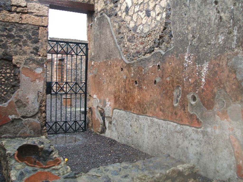 I.13.13 Pompeii. December 2004. North-east corner with doorway to atrium of I.13.12, and east wall.