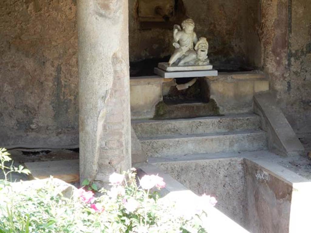 II.2.2 Pompeii. May 2016. Room “l”, garden. Looking north to marble steps in the nymphaeum at the northern end of the lower euripus. A white statuette of a cupid with a mask has now been replaced there.  Photo courtesy of Buzz Ferebee.
