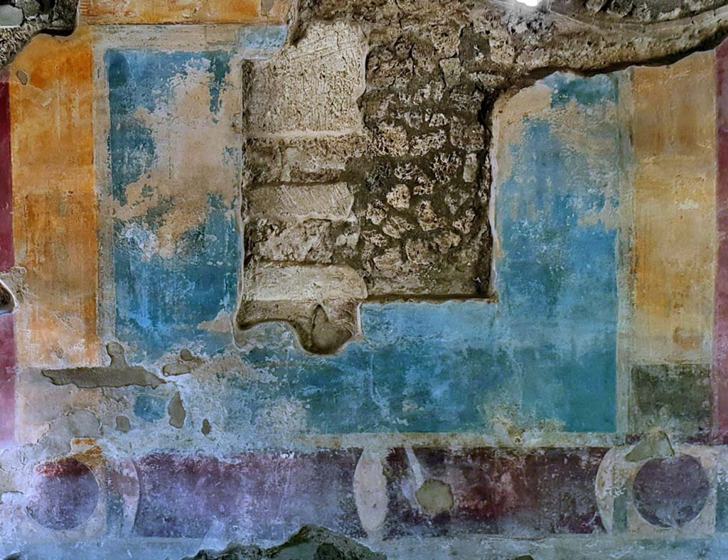 II. 4. 3 Pompeii. August 2012. Atrium, west wall. Fresco in fourth style. Photo courtesy of Davide Peluso.
According to PPM, the painting (m 105 x 113) in the centre of a blue panel was not found at the time of the excavation in the mid 1750s.
See Carratelli, G. P., 1990-2003. Pompei: Pitture e Mosaici, III. Roma: Istituto della enciclopedia italiana, p. 251. 
