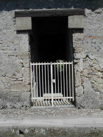 II.9.4 Pompeii. December 2007. Plaster on lower corner of north side of fauces wall.