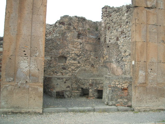 V.1.5 Pompeii. May 2010. North wall with door to rear room, niche and boilers.