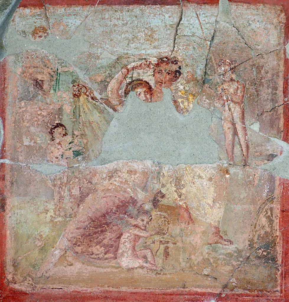 V.1.18 Pompeii. March 2009. Exedra “o” on north side of peristyle. North wall.  
Remains of wall painting of Venus at her toilette with Mars at her shoulder and with four cupids.
Sogliano refers to them as Ares and Aphrodite. A cupid, sitting between their feet, plays with Mars helmet.
A cupid to the left presents a small green box. Above left a third cupid holds a sword. 
The cupid to the right takes the lance. A shield is seen on the lower right.
See Schefold, K., 1957. Die Wände Pompejis. Berlin: De Gruyter.  p. 65.
See Sogliano, A., 1879. Le pitture murali campane scoverte negli anni 1867-79. Napoli: Giannini. (p. 34, no.139).

