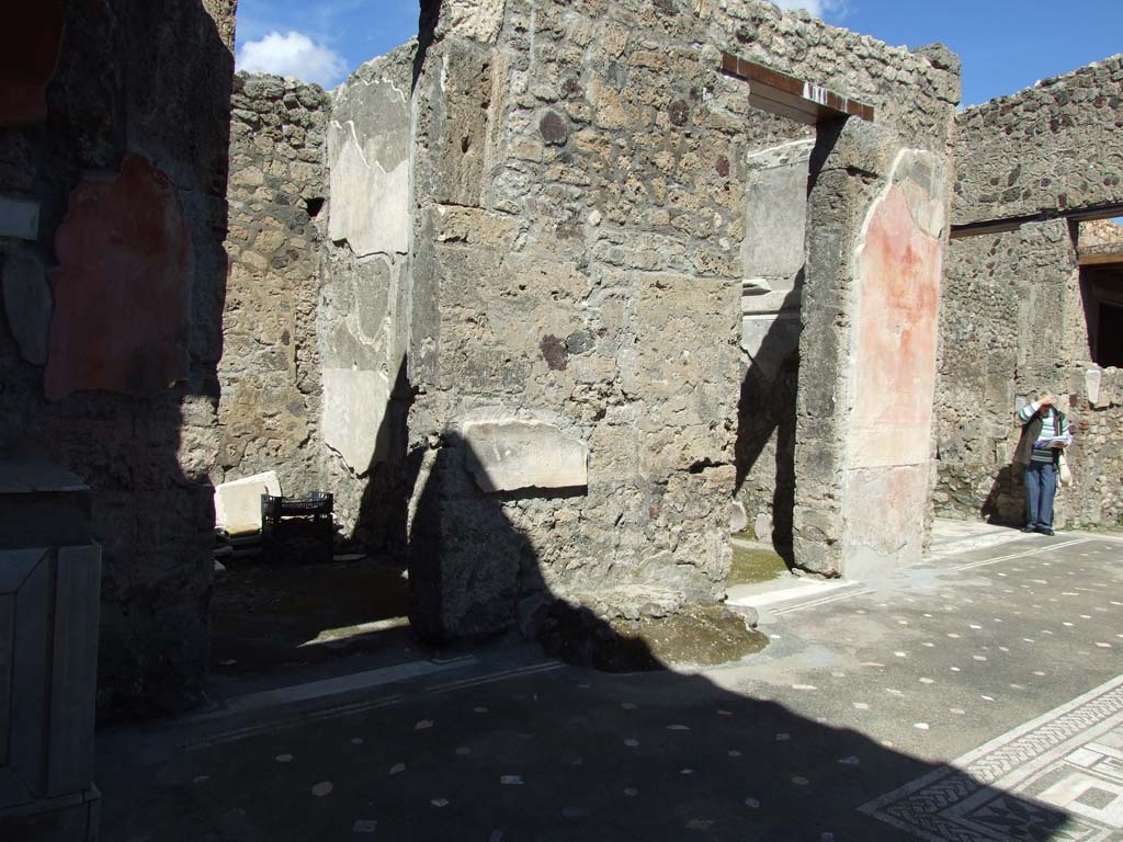 V.1.26 Pompeii. October 2023. 
Room 1, north-west corner of atrium with marble lararium. Photo courtesy of Johannes Eber.

