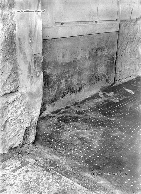 V.2.h Pompeii. December 2005. Kitchen in north-east corner of atrium, with hearth. According to Boyce, the lararium was on the south wall. On the right of the picture can be seen the remains of the lararium serpents. See Boyce G. K., 1937. Corpus of the Lararia of Pompeii. Rome: MAAR 14. (p.37, no.107, Pl.17,2) 