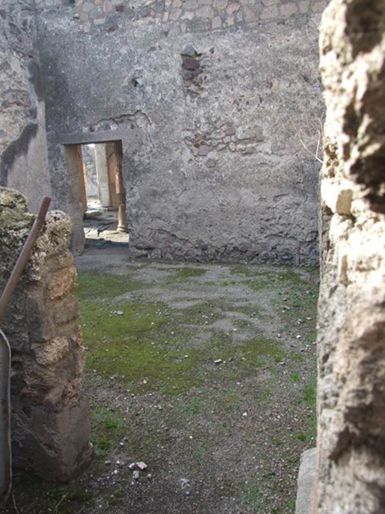 VI.1.7 Pompeii. December 2007. Looking south-west through doorway into room 23, from room 22. On the south side of the west wall can be seen the doorway from the east portico.
