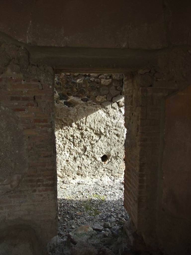 VI.1.7 Pompeii. December 2007. 
Doorway to room 24, services room for the baths area, in south-east corner of portico.
In the east wall, one of the two conduits acting as vents from the adjacent praefurnium can be seen.

