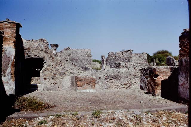 VI.1.13 Pompeii.  May 2006. South wall and Via Consolare, looking south.