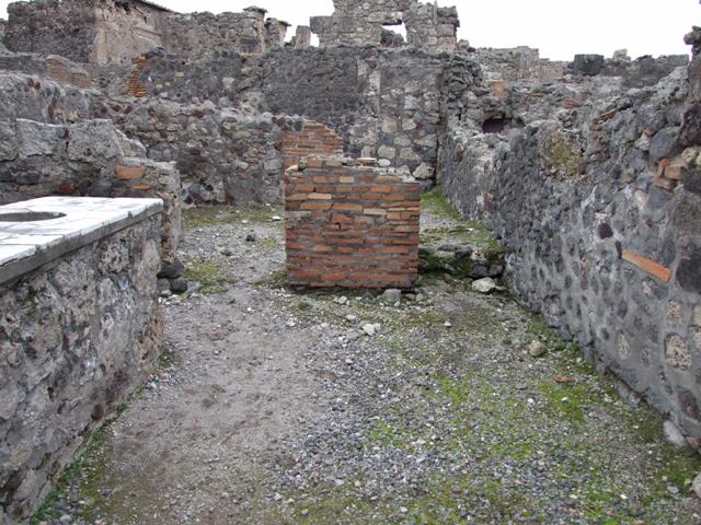 VI.1.17 Pompeii. May 2010. Looking west across bar towards Via Consolare
In the rear room, the remains of the steps to upper floor can be seen on the left.