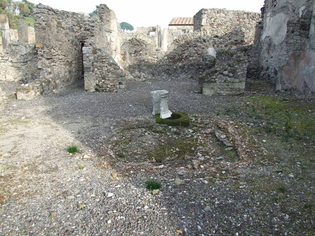 VI.2.17 Pompeii. September 2005. Looking east across atrium with impluvium, towards tablinum.For photos of the east part of this linked house, see VI.2.20. According to Garcia y Garcia, in this house there was much damage caused by the two bombs that fell on the nearby house to the north. After the bombardment, it was left in a state of grave abandonment. See Garcia y Garcia, L., 2006. Danni di guerra a Pompei. Rome: L’Erma di Bretschneider. (p.74)