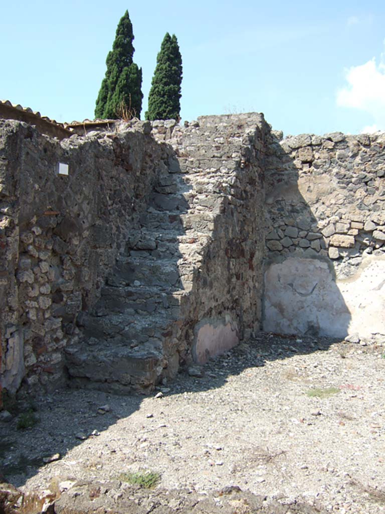 VI.2.26 Pompeii. September 2005. Looking north towards steps to upper floor against west wall of yard area.