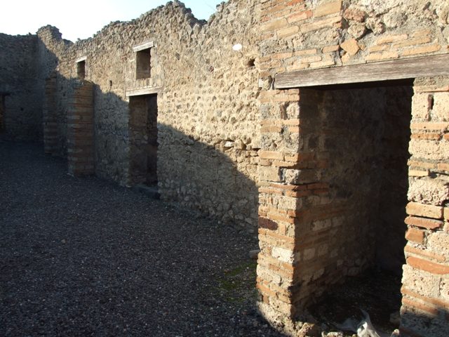 VI.7.15 Pompeii. May 2005. Looking west from entrance across yard towards kitchen area and doorway to dormitory.