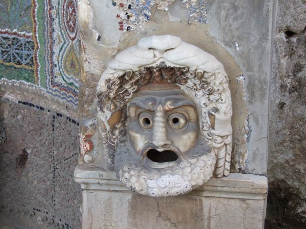 VI.8.22 Pompeii. March 2009. Hollow marble mask of bearded male figure on north side of fountain, used as a lamp at night.
