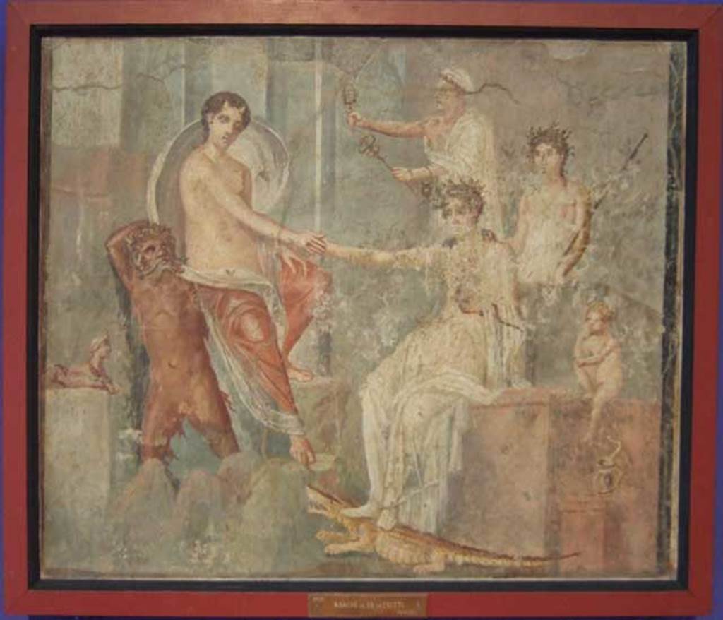VI.9.1 Pompeii. Painting of the Arrival of Io at Canopus. From a room north of the atrium. 
Io is depoasited on the rocks at Canopus carried by a river god, probably the Nile. She is being greeted by Isis. Behind Isis stand two figures, possibly Mercury and a priest. The small Harpocrates is to the right of the painting with his hand to his lips in the gesture of silence. To the left of the river god is a sphinx, and under Isis foot is a crocodile and a cobra. Now in Naples Archaeological Museum. Inventory number 9555. The house was named after this painting. See Zahn in BdI 1831 p. 18. See Helbig, W., 1868. Wandgemlde der vom Vesuv verschtteten Stdte Campaniens. Leipzig: Breitkopf und Hrtel. (139).