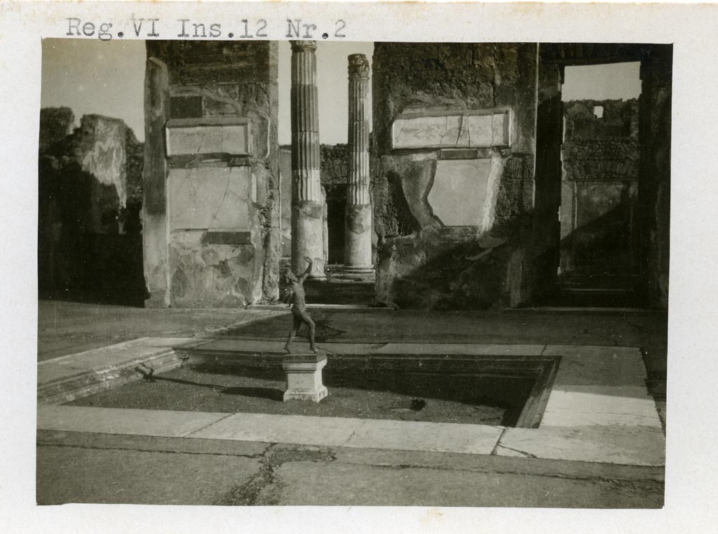 VI.12.2 Pompeii. pre-1937-39. 
Looking east across impluvium in atrium towards doorway to ala 11 into atrium of VI.12.5, in centre. 
On the right is the doorway to a cubiculum 10.
Photo courtesy of American Academy in Rome, Photographic Archive. Warsher collection no. 1416
