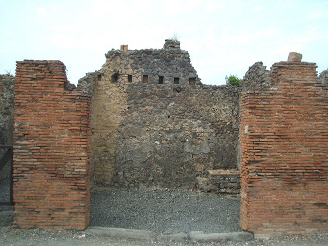 VI.14.6 Pompeii. December 2006. North wall of shop, with base of stairs in north-east corner.