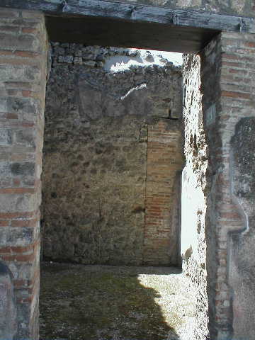 VI.14.29 Pompeii. May 2005. Looking west through entrance doorway.
According to Wallace-Hadrill, originally this would have been a room from VI.14.30 on the south side of the fauces. It had Style III decoration.
See Wallace-Hadrill, A. (1994): Houses and Society in Pompeii and Herculaneum. Princeton Univ. Press, (p. 213)
