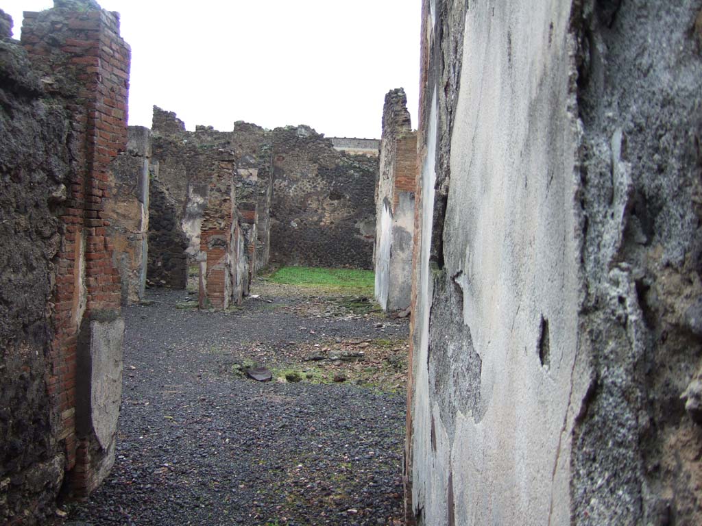 VI.14.42 Pompeii. December 2005. Looking east across atrium and small tablinum towards garden area at rear.
According to Jashemski, the small garden at the right rear of the house, excavated in 1846, was visible from the entrance doorway through the atrium and tablinum.
It had a covered passageway on the west side. The triclinium to the north of the garden had a wide window looking into the garden.
See Jashemski, W. F., 1993. The Gardens of Pompeii, Volume II: Appendices. New York: Caratzas. (p.151)
