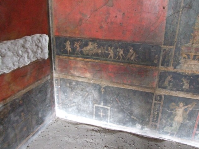 VI.15.1 Pompeii. December 2006. South wall in south-east corner with painting of cupids taking part in an archery or throwing contest.