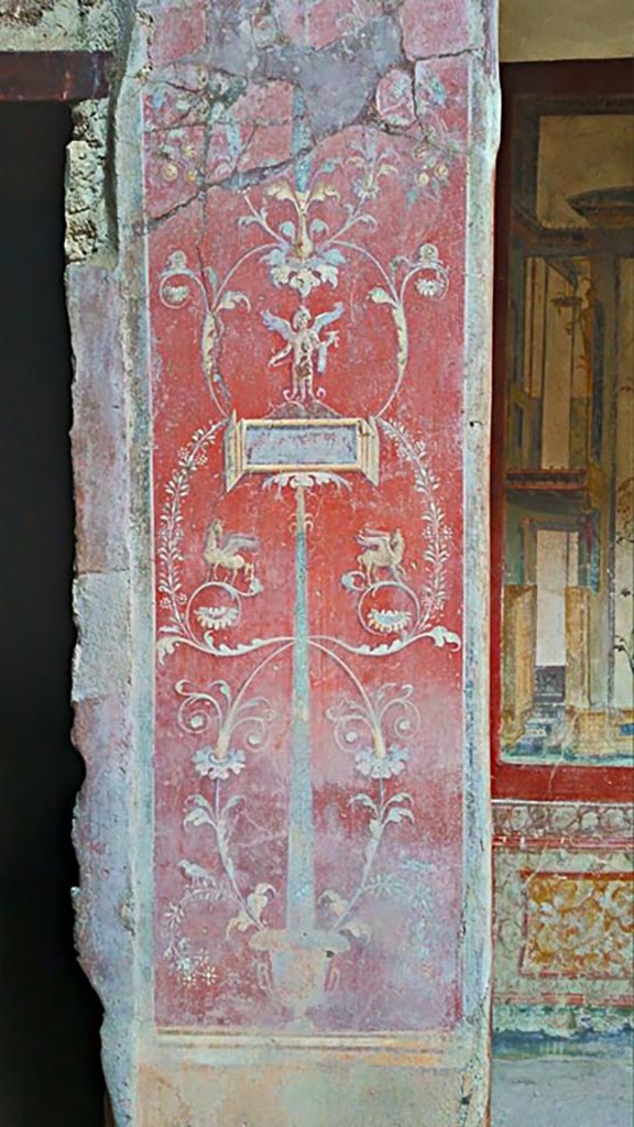 VI.16.15 Pompeii. 2015/2016. 
Painted pilaster on west side of atrium B with doorway to room C, on left. 
Photo courtesy of Giuseppe Ciaramella.

