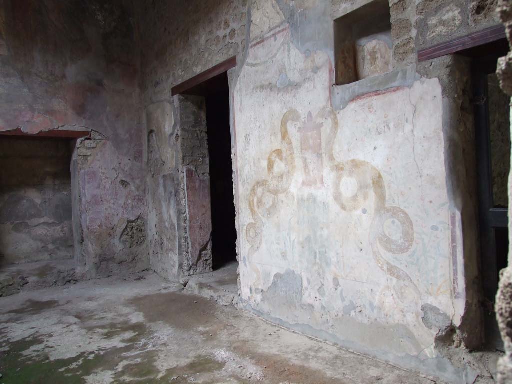 VI.16.15 Pompeii. December 2006. North-west corner of atrium B, with doorway to room E, on left.
Doorways to rooms I and K are separated by the painted lararium on the north wall. 
