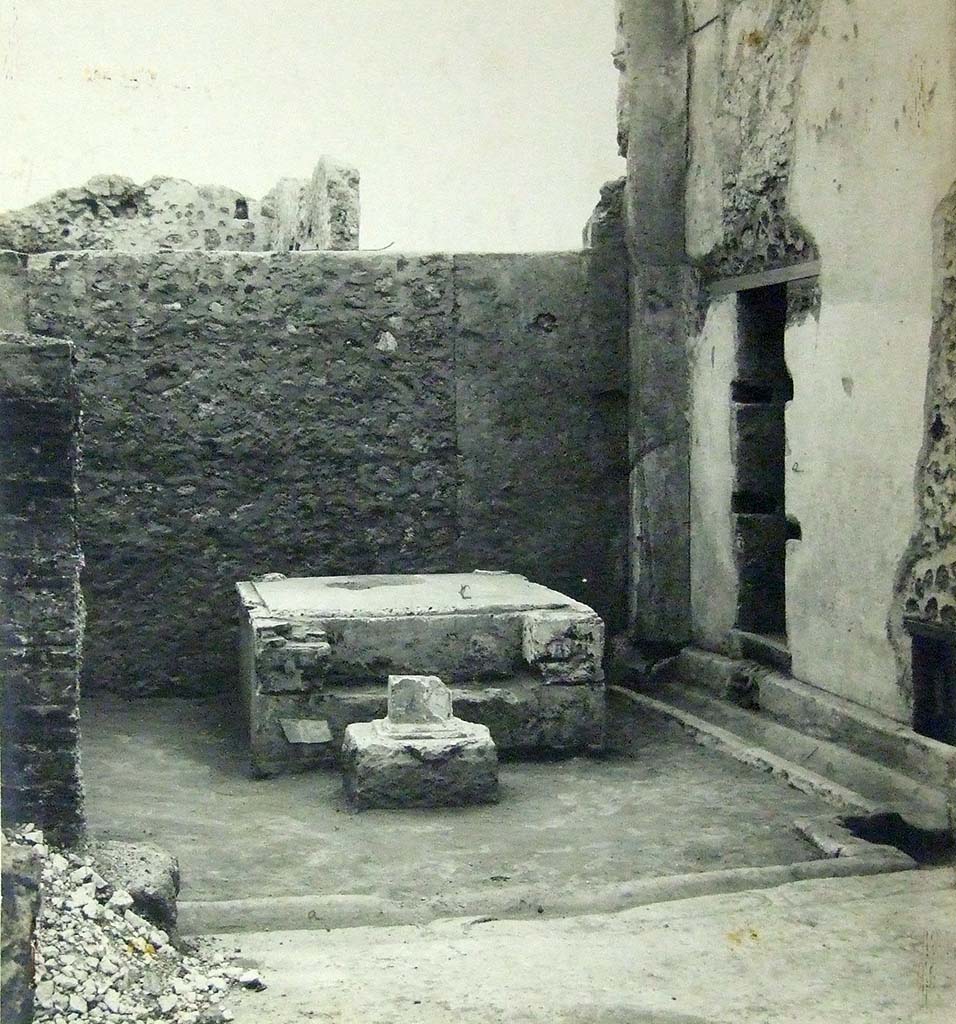 VII.6.3 Pompeii. 1910. Room 18, viridarium in south-west corner of the peristyle. 
Base of a Temple Lararium shrine (r) with a small altar in front.
According to Jashemski, 
Professor Richardson has shown that the well-known archaic statue of Diana, (Mus. Naz. Inv. No. 6008) which was found at Pompeii in 1760, came from the large and elegant shrine in the south-west part of the garden. There was a tufa altar in front of the shrine.
See Jashemski, W. F., 1993. The Gardens of Pompeii, Volume II: Appendices. New York: Caratzas. (p.184).
Photograph courtesy of Soprintendenza Speciale per i Beni Archeologici di Napoli e Pompei.
