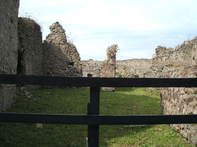 VII.6.16 Pompeii. Looking west to site of rear room (on left), and corridor leading to VII.6.11 (on right).
