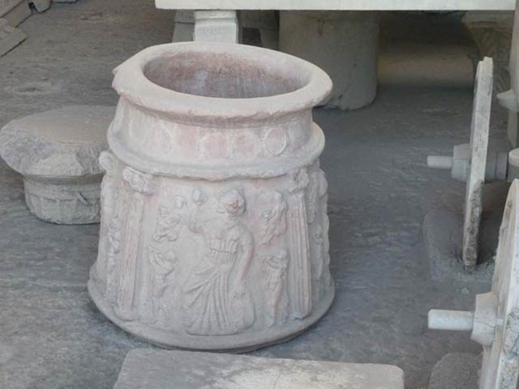 VII.7.29 Pompeii. September 2015. 
Terracotta puteal in storage,(from I.13.8?) with moulded decoration of columns and Bacchic figures. Photo courtesy of Buzz Ferebee.
According to Roberts,
there are three scenes divided by columns each showing a Maenad with tambourine and castanets with seated figures, perhaps Bacchus, and satyrs playing the twin pipes (auloi).
See Roberts, P., 2013. Life and Death in Pompeii and Herculaneum. London: British Museum Press, p. 153, fig. 167.
PAP inventory number 44908.


