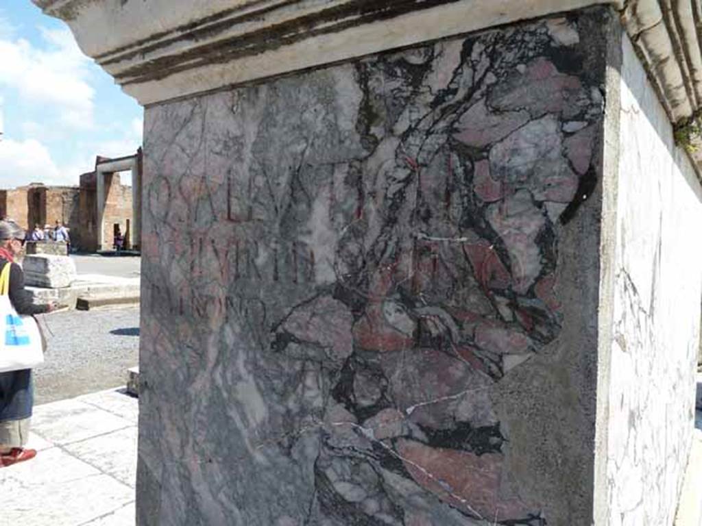 VII.8 Pompeii Forum. December 2007. South-east corner. Red and black marble base west side, with Latin inscription:

Q. SALLVSTIO P. F.
II. VIR I. D. QVINQ
PATRONO D. D.

See Pappalardo, U., 2001. La Descrizione di Pompei per Giuseppe Fiorelli (1875). Napoli: Massa Editore. (p.102)

According to Epigraphik-Datenbank Clauss/Slaby (See www.manfredclauss.de) this read

Q(uinto) Sallustio P(ubli) f(ilio)
IIvir(o) i(ure) d(icundo) quinq(uennali)
patrono d(ecreto) d(ecurionum)      [CIL X, 792 (p 967) = IMCCatania 00538]

According to Cooley this translates as 

To Quintus Sallustius, son of Publius, duumvir with judicial power, quinquennial, patron. 
By decree of the town councillors.

See Cooley, A. and M.G.L., 2004. Pompeii : A Sourcebook. London : Routledge. F90, p. 130.
See Cooley, A. and M.G.L., 2004. Pompeii : A Sourcebook. London : Routledge. F90, p. 130.