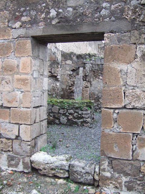VII.9.41 Pompeii. December 2005. Looking north to doorway in north-west corner of workshop, leading to rear room and entrance doorway to atrium of VII.9.40.